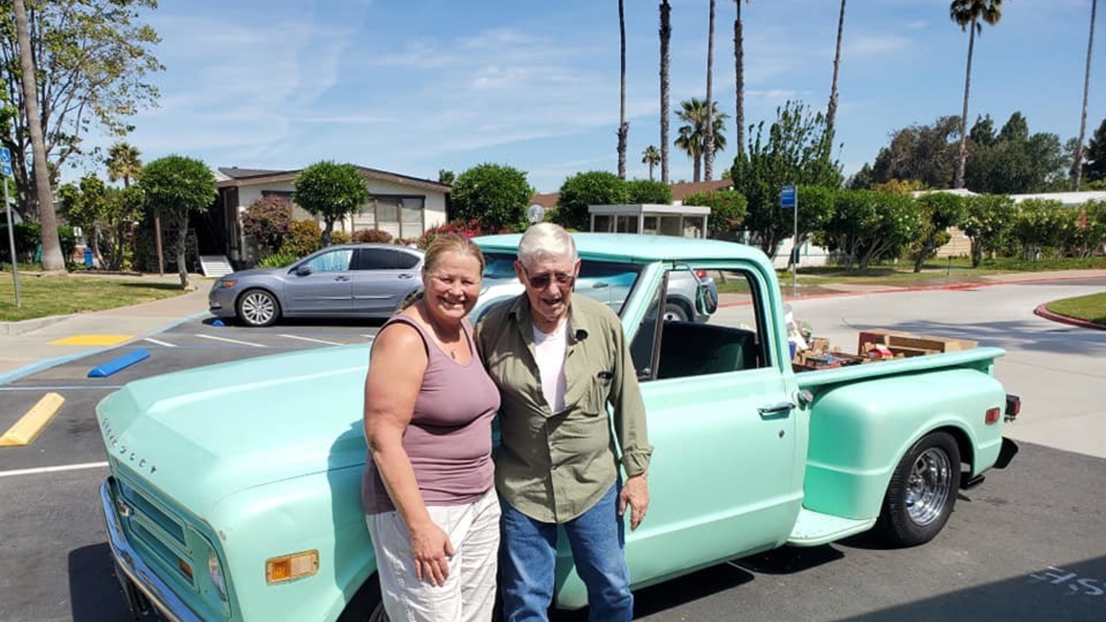 Couple poses in front of old truck