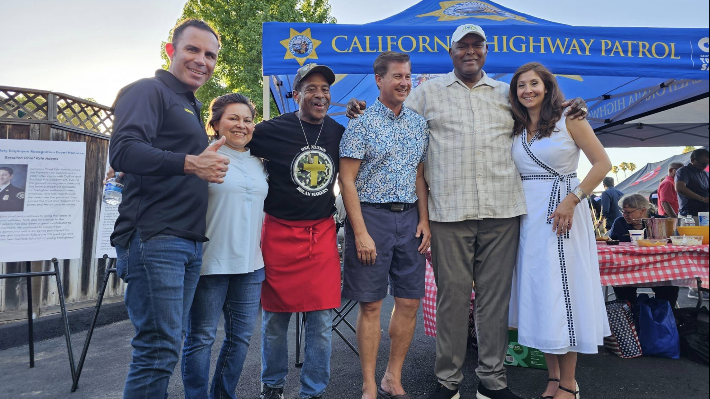 group-standing-for-photo-at-bbq