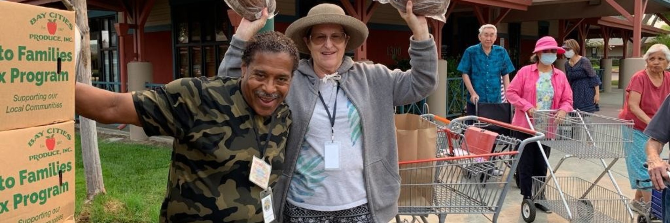 Ronnie Forbes poses with a volunteer at a food delivery
